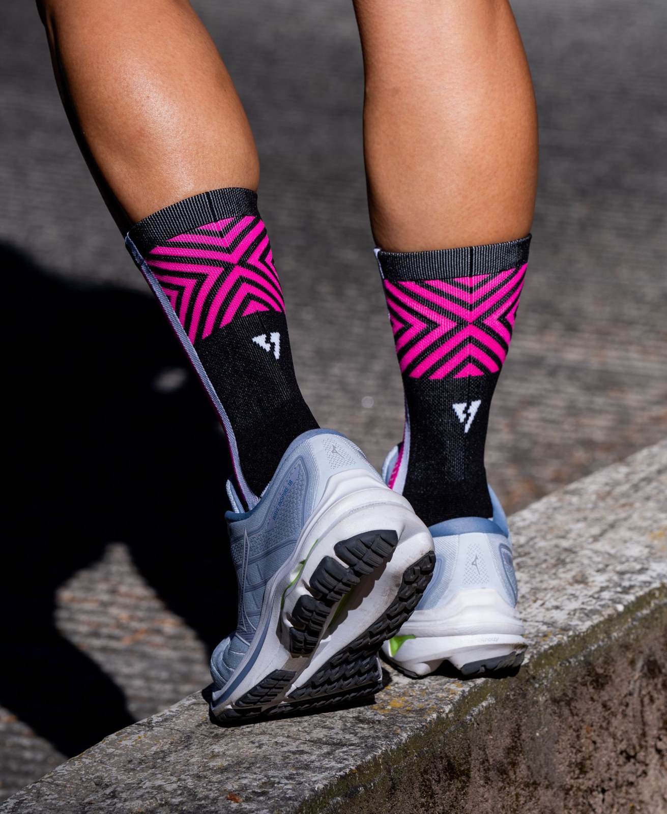 Close-up of patterned sports socks and running shoes.