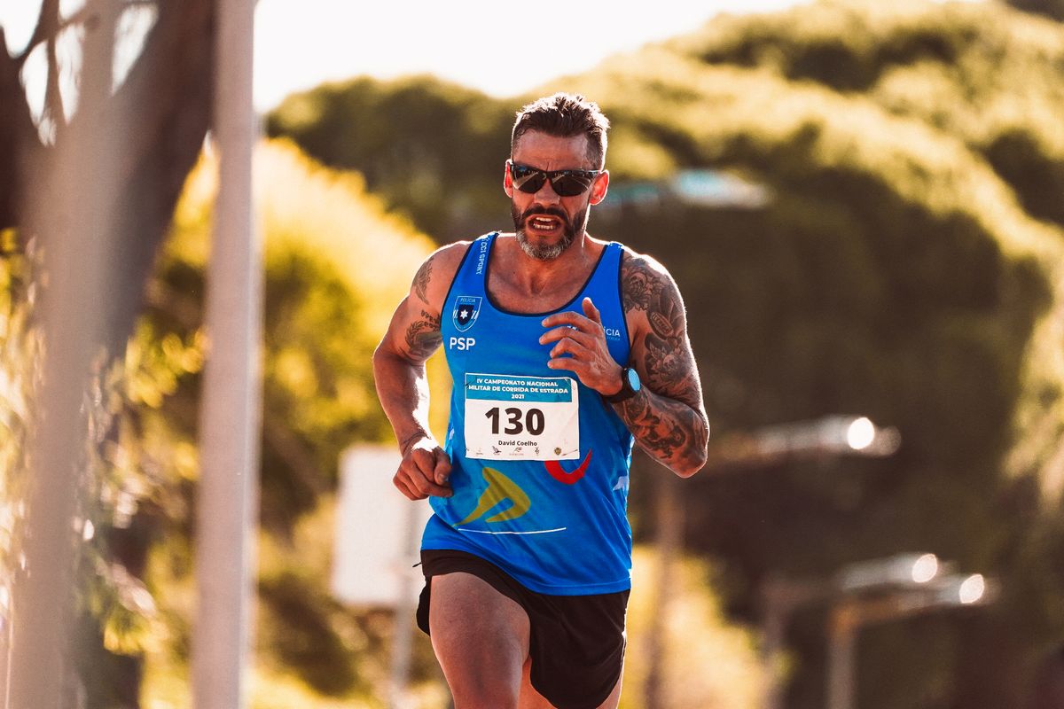 A road runner wearing close-fitting sports sunglasses.