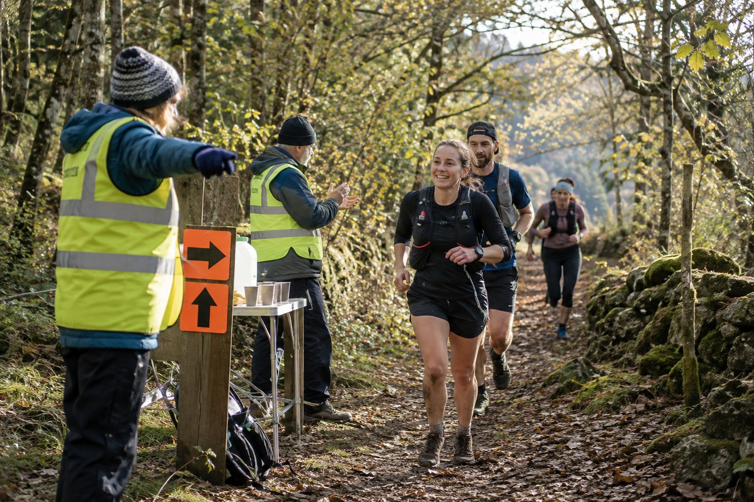 Marshals and direction markers at a woodland trail event.